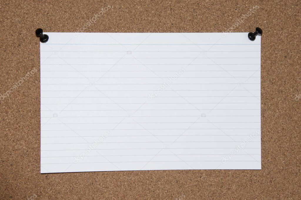 Cork board with tacks, white flash card