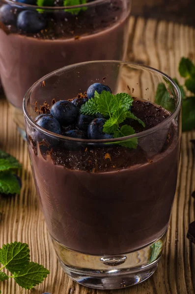 Chocolate pudding with berries and herbs — Stock Photo, Image