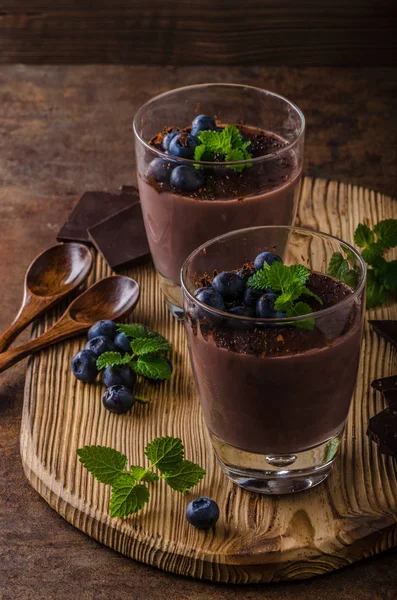 Chocolate pudding with berries and herbs — Stock Photo, Image