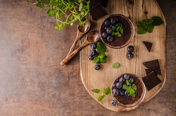 Chocolate pudding with berries and herbs — Stock Photo, Image