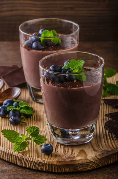 Chocolate pudding with berries and herbs — Stock Photo, Image