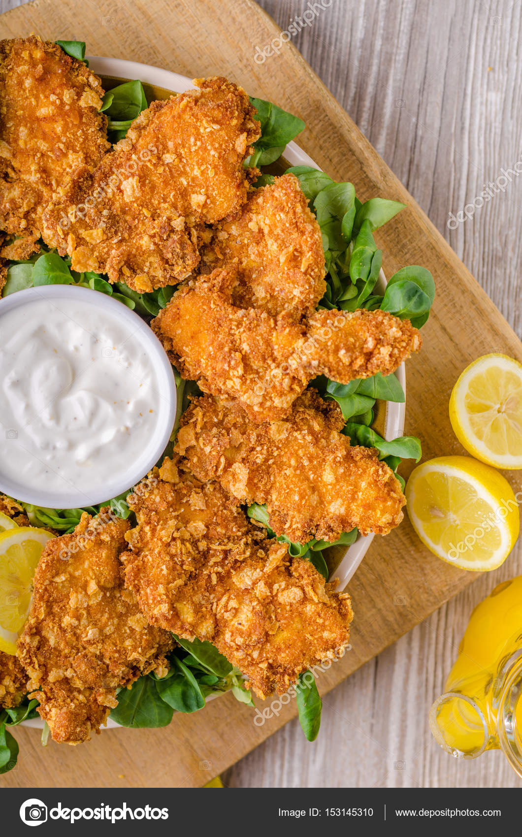 Chicken strips with delish garlic dip — Stock Photo © Peteer #153145310