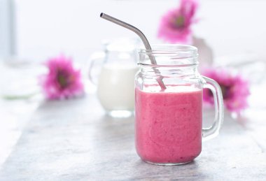 Bardakta beyaz ve pembe renkli güzel bir meyve püresi. Böğürtlenler. Süt doğal organik ürünler
