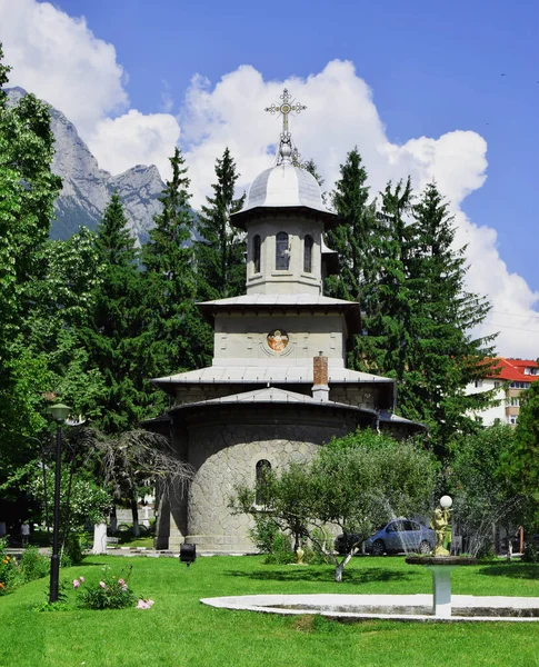 A Romanian church with the mountain in the back