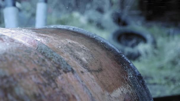 Drops Water Falling Top Orange Weathered Tank Tires Grass Background — Stock Video