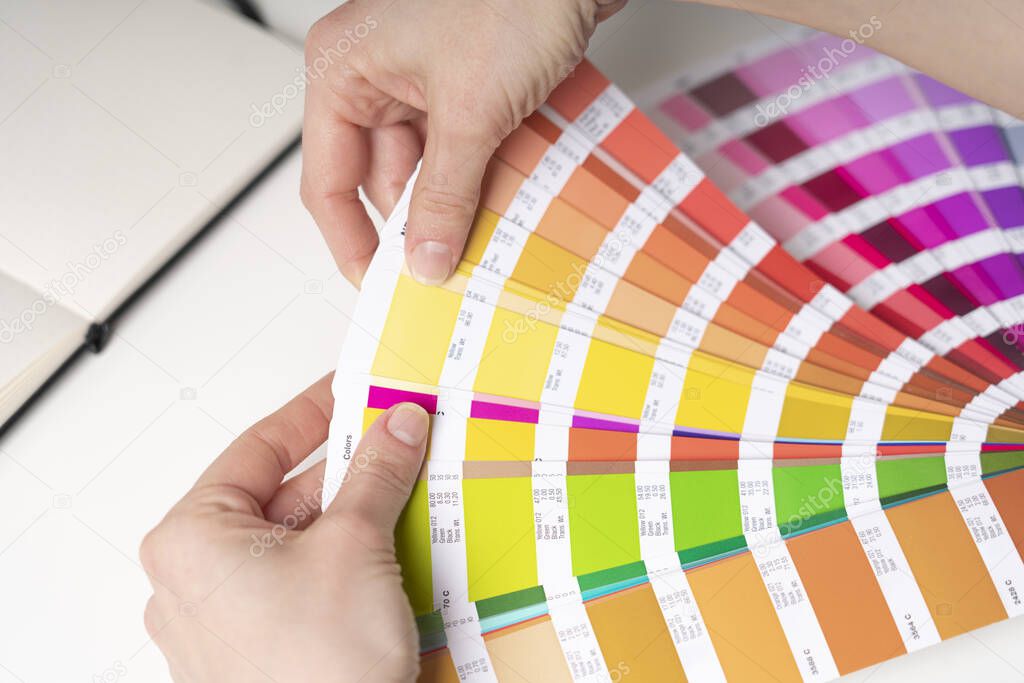 Graphic designer at work chooses color palette