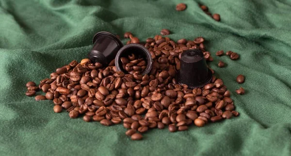 Italian espresso capsules or coffee pods with roasted coffee beans ready for a good day