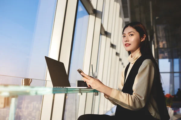 Kvinna kunnig bankman med cellen telefon i händer — Stockfoto