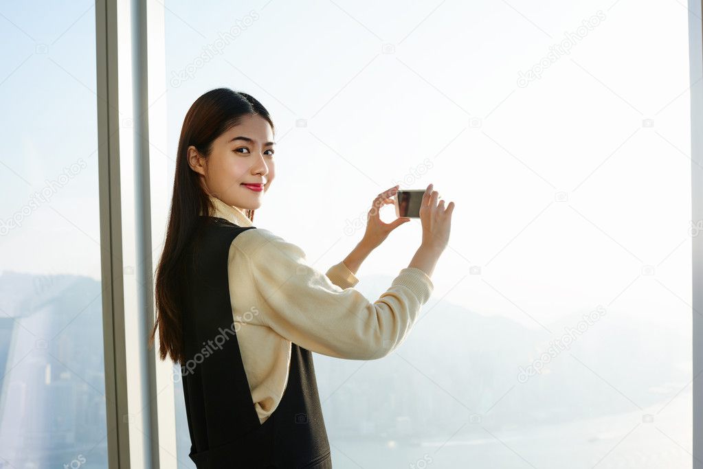woman is making photo with her mobile phone