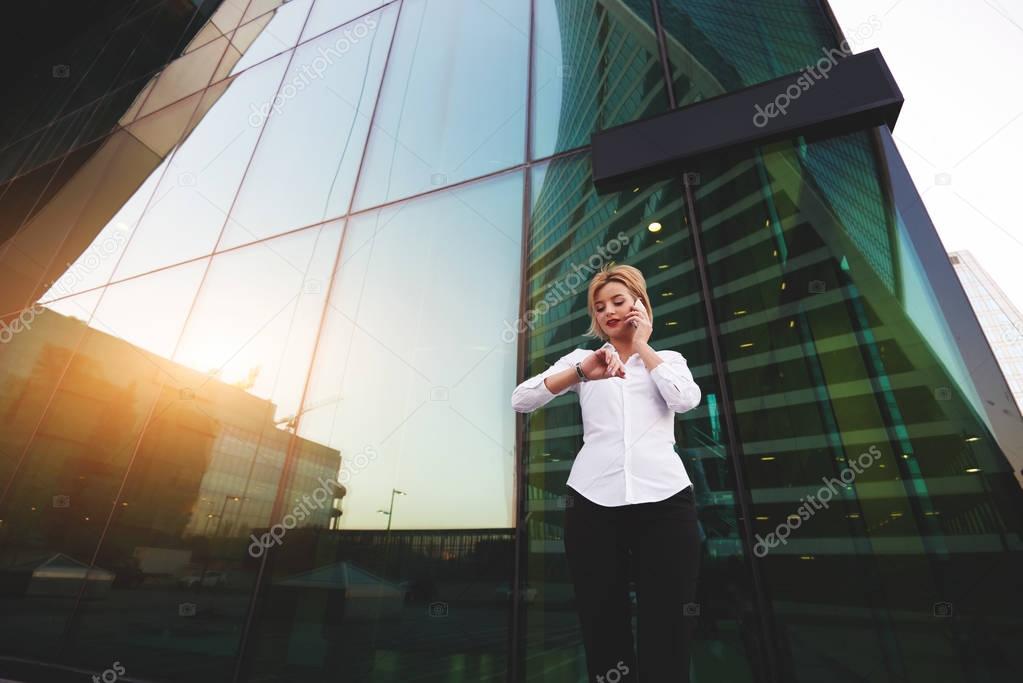 Young businesswoman is checking time