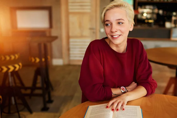 Estudiante internacional haciendo tarea en la lección de literatura mientras lee novela de ficción —  Fotos de Stock