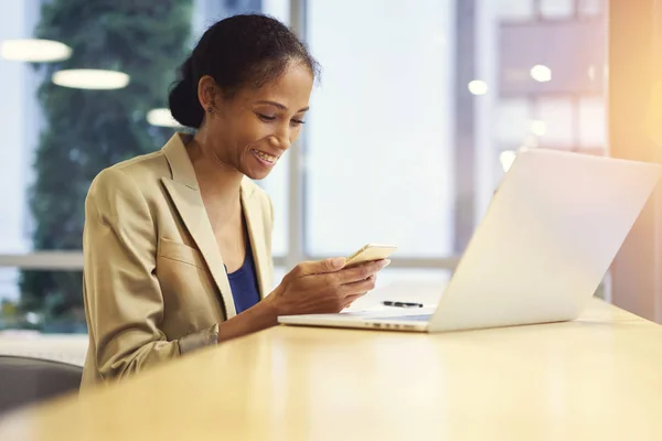 Portrait of smile afro american female blogger sharing multimedia files with followers waiting for feedback — Stok Foto