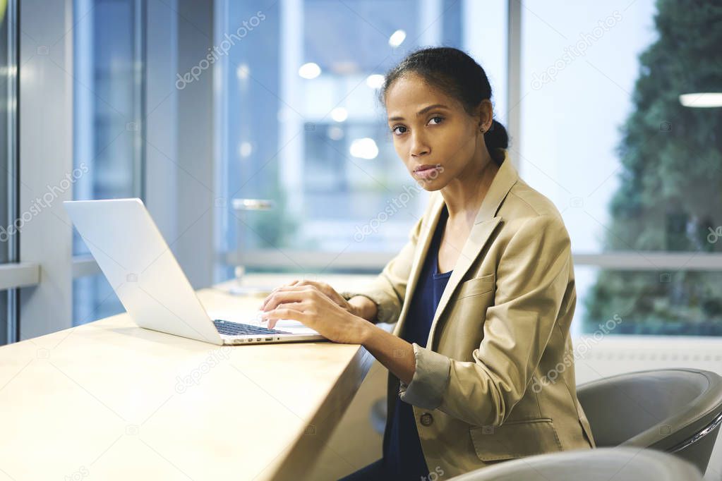 Concentrate skilled journalist using laptop and wifi connection in coworking office
