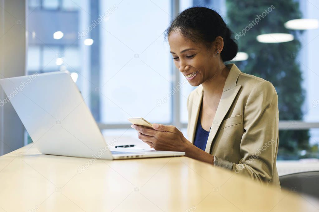 Attractive afro american female manager having fun during work break in office 