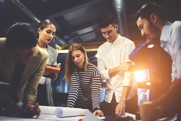 Tripulación de hipsters consultando con profesores cualificados corrigiendo errores y dando consejos durante la clase de formación en la universidad — Foto de Stock