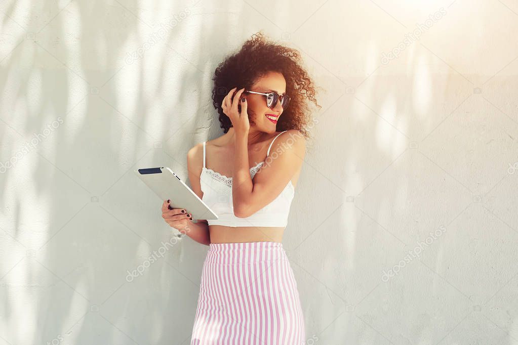 Well dressed woman using networking connection to internet on her digital tablet