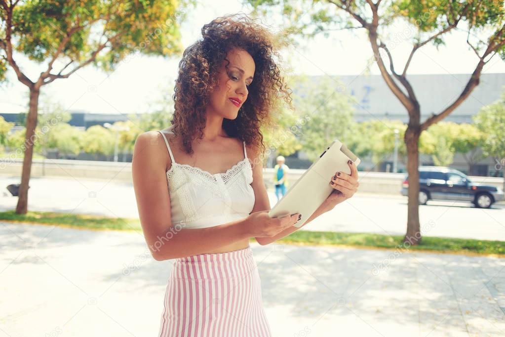 Female tourist using navigation   maps on digital tablet apps