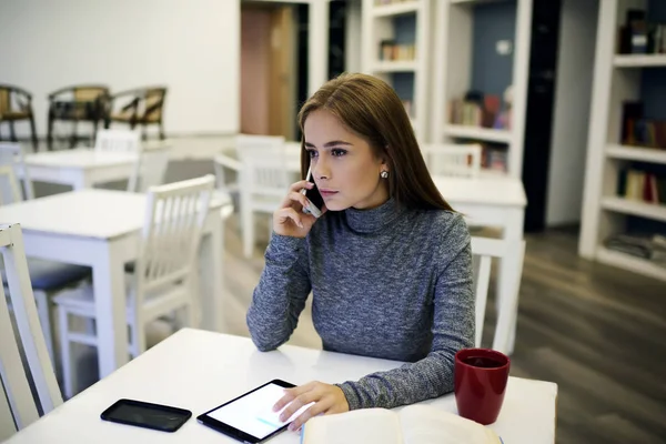 Likable girl  using touchpad and wireless connection for organizing work — Stock Photo, Image