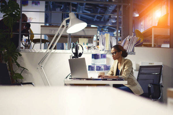 Professional female newsmaker monitoring latest event report from official media sites 