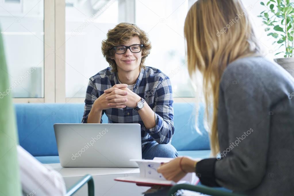 male student with female using laptop