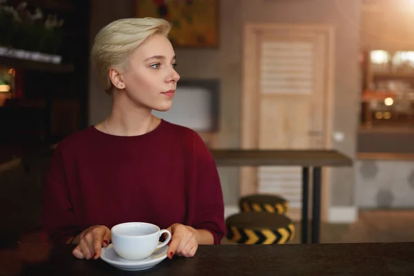 Female student drinking coffee