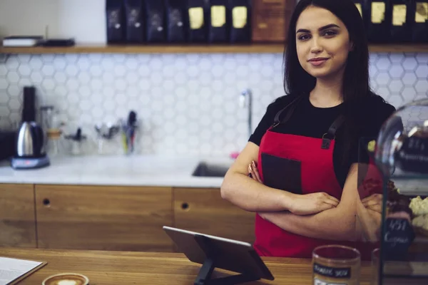 Professional female barista waiting for order to make aroma coffee for client standing near modern equipment — Stock Photo, Image