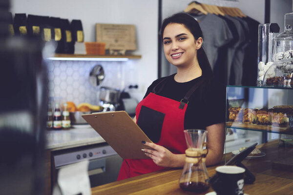 Smiling administrative manager counting annual income from service and sales