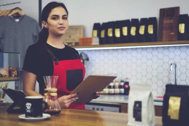 beautiful waitress having working day in coffee shop using digital touch pad device clipart