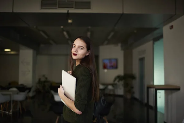 Successful female architect preparing to work in coworking space with laptop and backpack — Stock Photo, Image