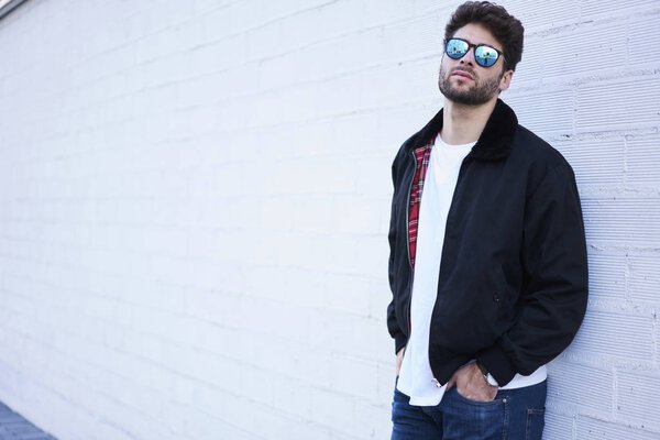 Handsome Spanish man posing near copy space area for advertising or promotion