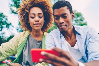 Güzel kadın ve yakışıklı adam beraberlik selfie smartphone kamera ve görüntü arkadaş grubu yapılan pay alarak görüntü kırpılmış. İyi görünümlü afro Amerikan hipsters açık havada vakit