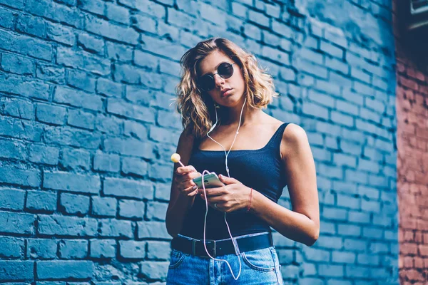 Attractive Woman Sunglasses Holding Lollipop While Listening Music Application Phone — Stock Photo, Image