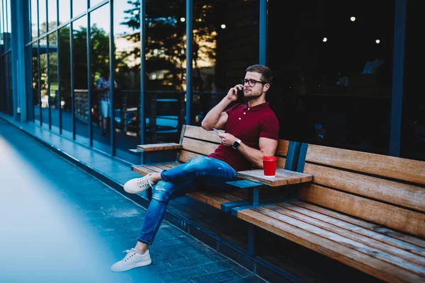 Stylish Young Man Eyeglasses Talking Mobile Phone Sitting Wooden Bench — Stock Photo, Image