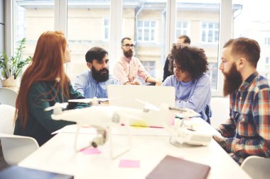 Kalifiye çalışanı hipster çocuklar konferans salonu ile teknoloji çalışma işlemi sırasında oturum beyin fırtınası sahip yeni proje tasarlamak için yaratıcı fikirler tartışırken Koç ile toplantısı