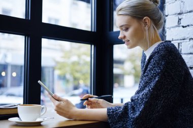 Dijital tablet kafede, çekici hippi kız online ödeme yolu ile modern dokunmatik yüzey mağaza web alışveriş yapma online para kazanmak hakkında bilgi tarama vasıflı serbest meslek konsantre