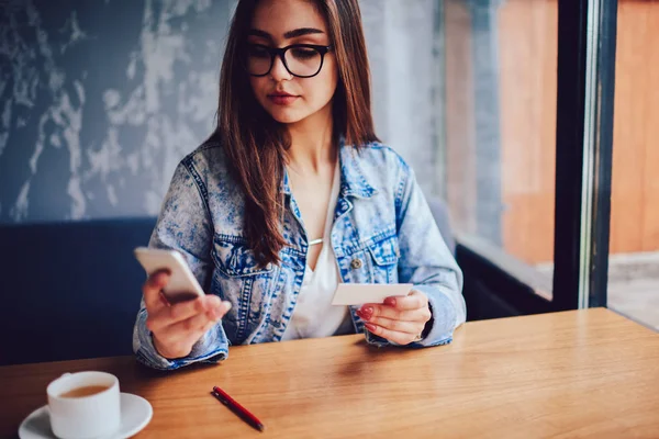 Serious Young Woman Stylish Eyeglasses Holding Business Card Hand Dialing — Stock Photo, Image