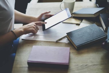 Erkek kırpılmış görüntü holding modern touchpad ile sahte kopya alanı ekranı reklam için eller. Öğrenci sınava hazırlanırken touchpad yararlı bilgiler tarama