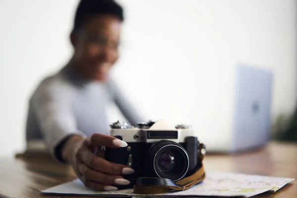 选择专注于老式相机站在正面 而年轻的女美国黑人摄影师坐在模糊的背景与复制空间区域的广告内容或文本信息 — 图库照片