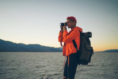 Badwater Milli Parkı, genç kadın kuru göl surfac benzersiz jeolojik çevre ile vahşi topraklarda hiking panoramik manzara resmini yapım profesyonel kadın fotoğrafçı