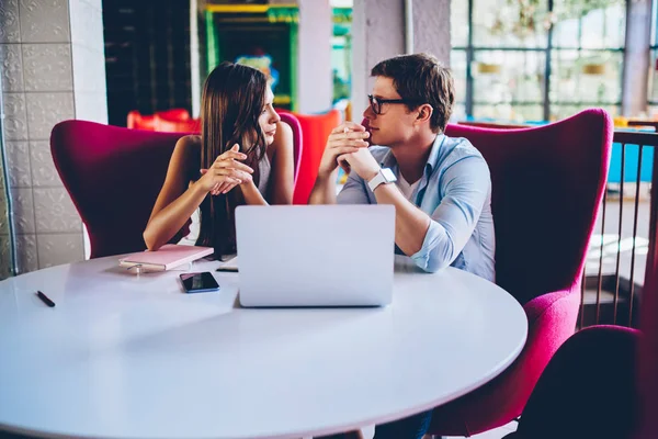 熟练的男女雇员在 Coworking 办公室规划项目会议期间互相交谈 年轻学生在学习时使用笔记本电脑进行交流以搜索信息 — 图库照片