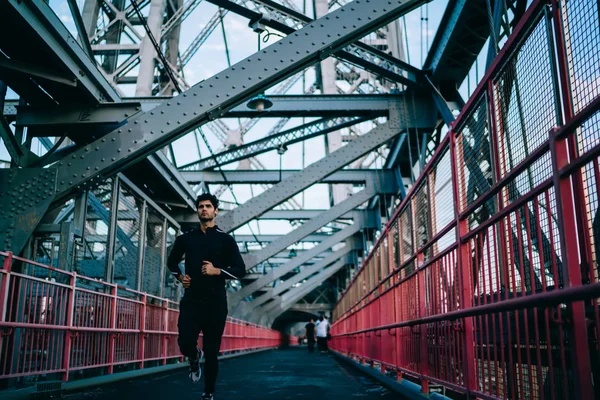 Motivated Young Athlete Dressed Black Tracksuit Running Outdoors Bridge Morning — Stock Photo, Image