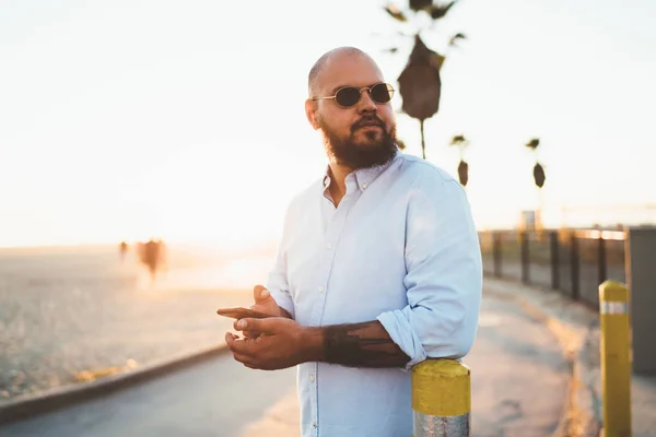 Serious Hipster Guy Looking Away Standing Outdoors Smartphone Hands Sending — Stock Photo, Image