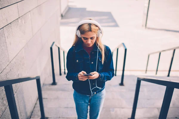 Smart Young Woman Stylish Headphones Downloading Audio Book Smartphone Standing — Stock Photo, Image