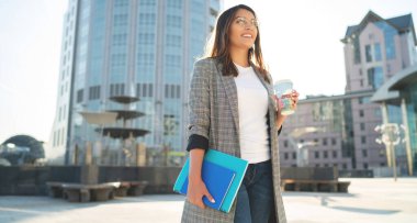 Kafein molası sırasında şehir ortamında güneşli havanın tadını çıkaran eskizler çizen, tipik bir hippi kız. Kahveli mutlu Türk kadın gözlerini kaçırıyor.