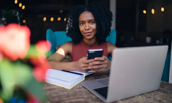 Retrato Blogueira Feminina Alegre Sorrindo Para Câmera Enquanto Senta Mesa — Fotografia de Stock