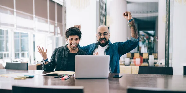 Trendy Ethnic Men Table Stylish Office Watching Laptop Raising Arms — Stock Photo, Image