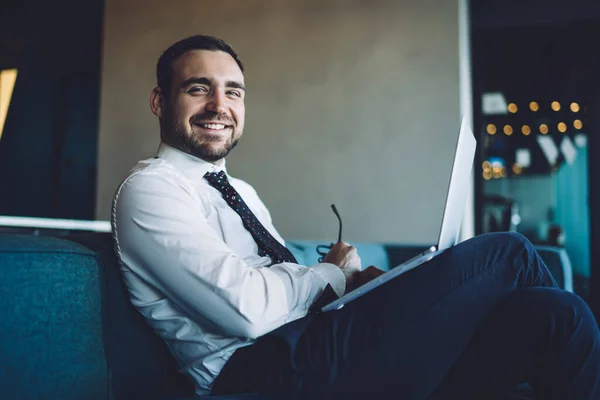 Retrato Homem Alegre Especialista Sentado Sofá Com Dispositivo Laptop Sorrindo — Fotografia de Stock