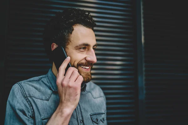 Cheerful Bearded Hipster Blogger Looking Away While Calling Smartphone Device — Stock Photo, Image