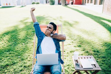 Kapalı gözleri olan yorgun bir erkek serbest gezgin dizüstü bilgisayarla proje planı yapmak için zaman gönderirken teslim tarihinden sıkılmış, modern netbook bilgisayarlı yetenekli bir adam.