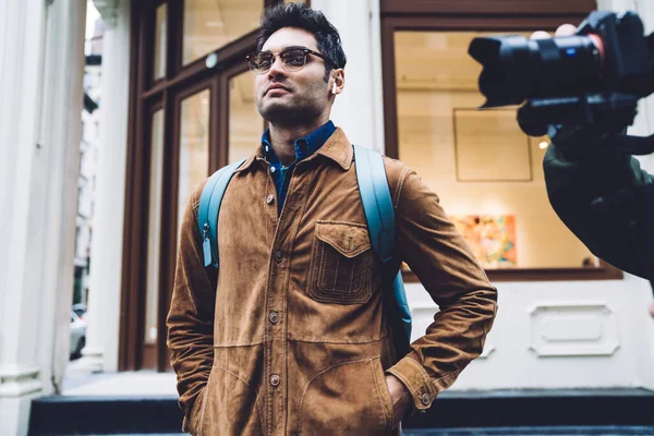 Pleased Handsome Hispanic Male Eyeglasses Wearing Brown Suede Jacket Backpack — Stock Photo, Image
